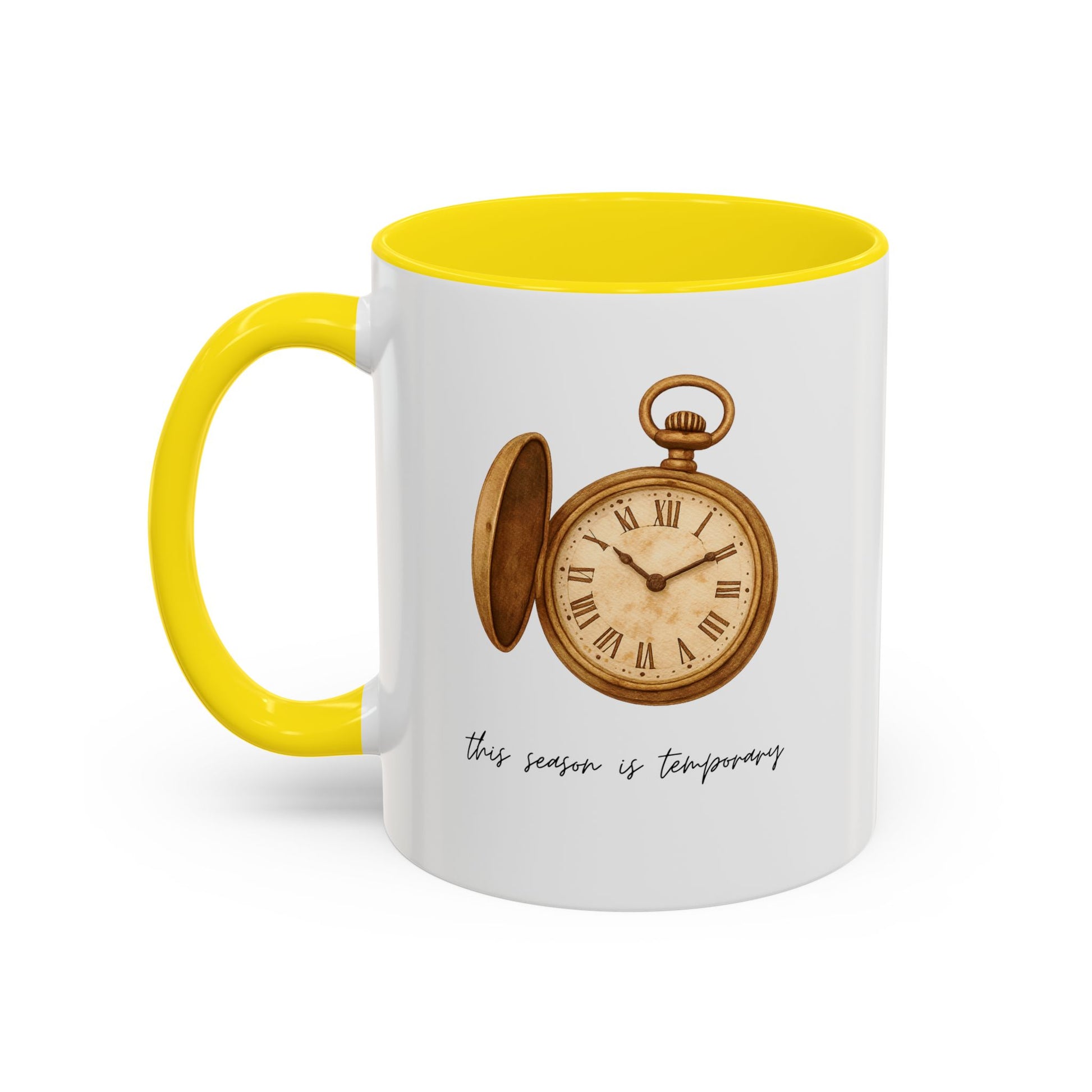 A white ceramic mug with a bright yellow handle and interior, featuring a printed illustration of an open vintage pocket watch and the phrase 'this season is temporary' in black script.